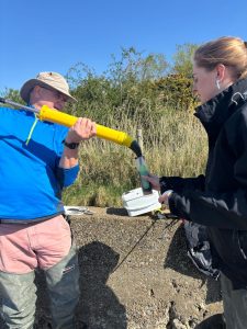 Tim Ferrero and Ellie Parker loading seed sediment into the canisters © Caitlin Woombs