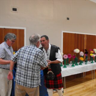 Prize giving at the 2012 Village Show, presenter congratulating winner.
