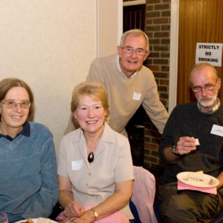 our attendees gathered around a table at a social event.