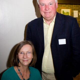 Allan Stansfield standing beside a seated guest at the Basinga 35th anniversary.
