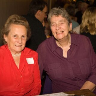 Rita Friedman and a guest seated at a table during the Basinga 35th anniversary.